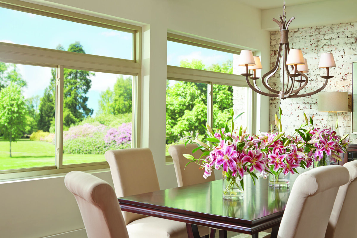 Dining room with vinyl replacement windows overlooking a garden in Overland Park, KS