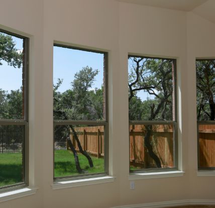 Exterior view of fiberglass-reinforced replacement windows on an Overland Park home