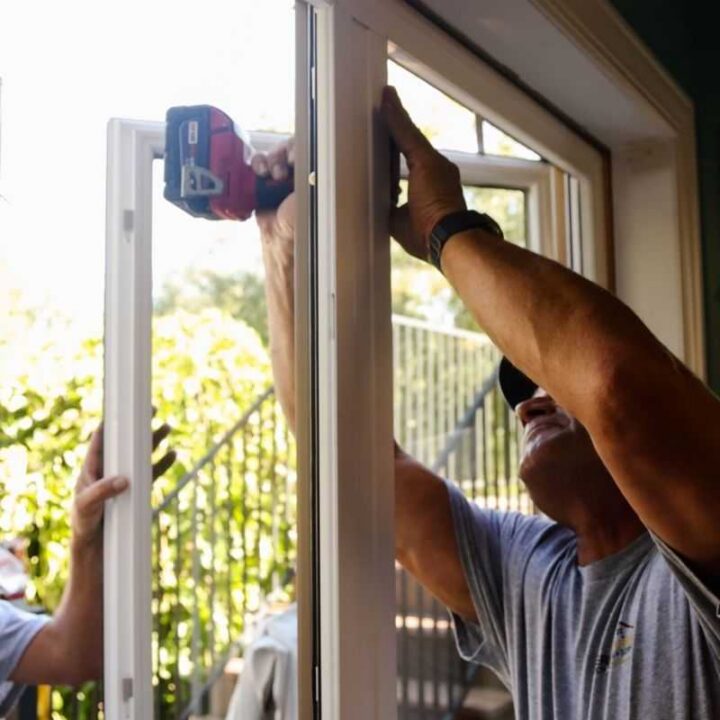 Installer sealing a fiberglass-reinforced vinyl replacement window in Overland Park